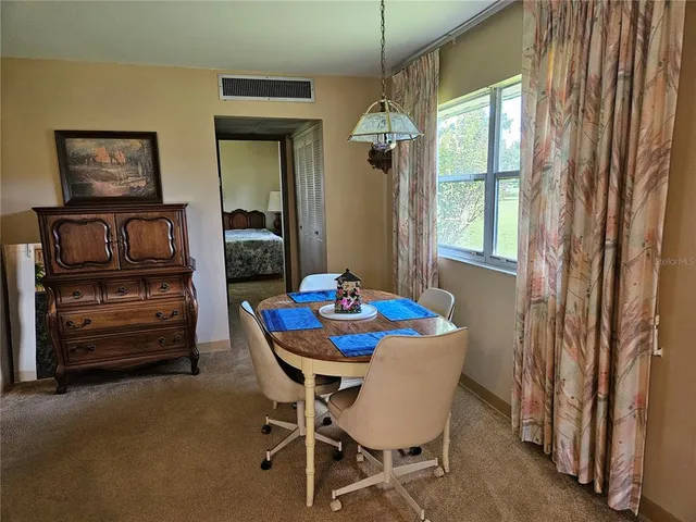 a dining room with furniture and window