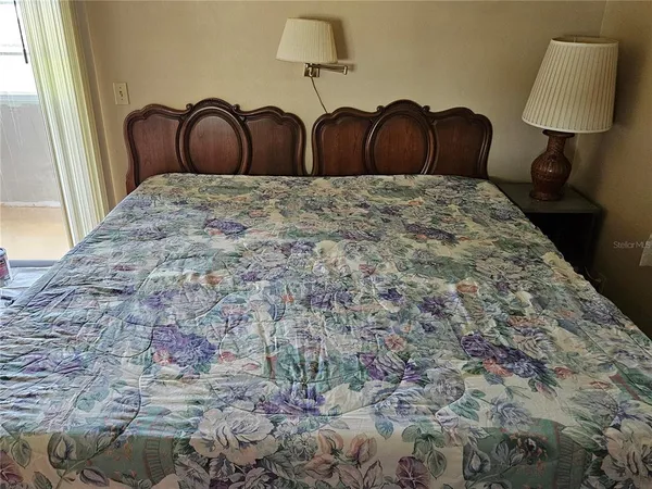 a bed with a black and white comforter