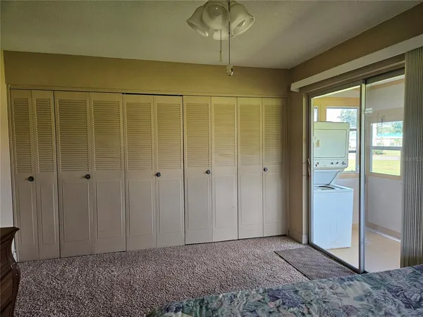 a spacious bedroom with a bed and dresser