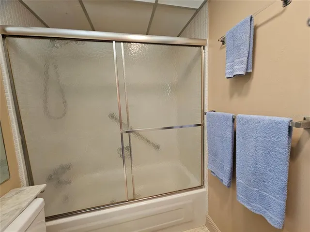 a bathroom with a bath tub with a shower