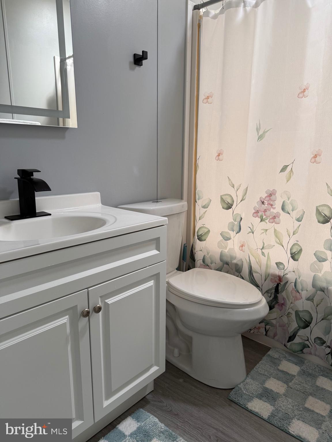 7959 Telegraph Road Severn, MD 21144 - Photo 5 of 18 a bathroom with a sink toilet and shower