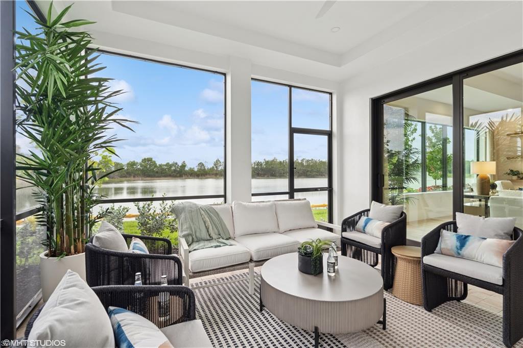 19781 Marino Lake Circle, Unit B4102 Miromar Lakes, FL 33913 - Photo 23 of 43 a living room with furniture and a large window