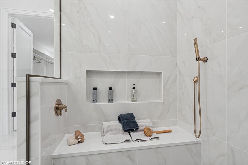 19781 Marino Lake Circle, Unit B4102 Miromar Lakes, FL 33913 - Photo 30 of 43 a bathroom with a tub and a shower