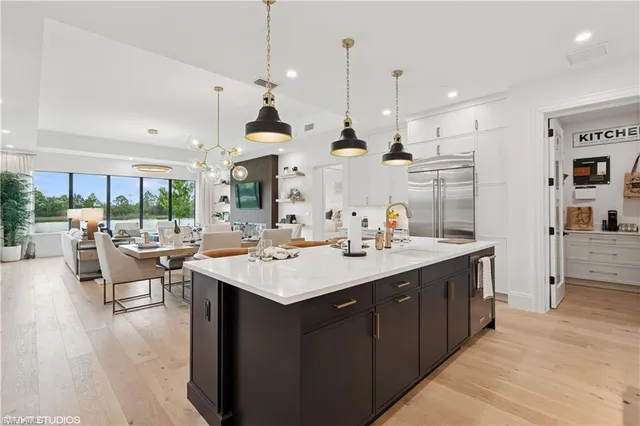 a large kitchen with a large counter top appliances and cabinets