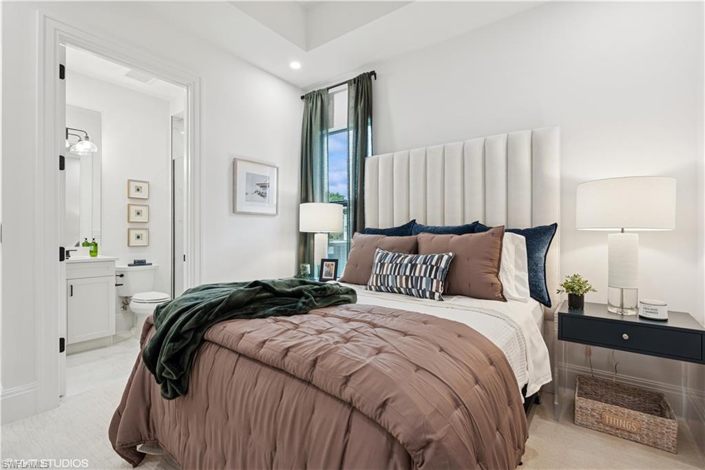 19781 Marino Lake Circle, Unit B4102 Miromar Lakes, FL 33913 - Photo 41 of 43 a bedroom with a bed and a lamp