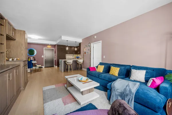 a bedroom with a bed and a flat tv screen on dresser