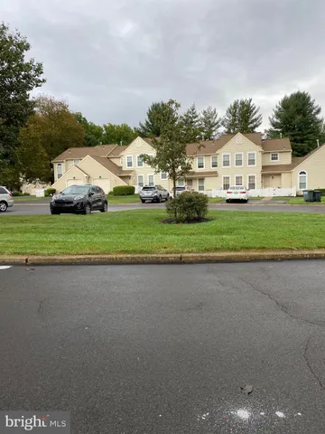 a view of green field with house in the background