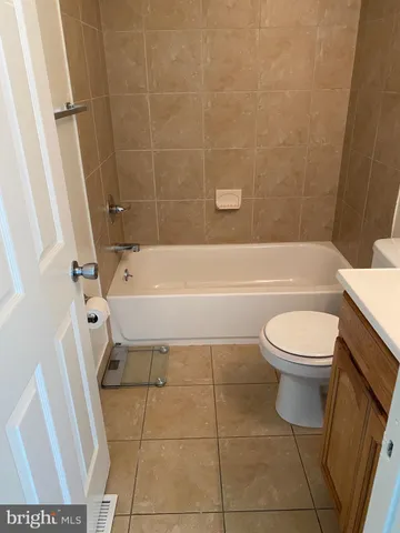 a bathroom with a sink a toilet and bathtub