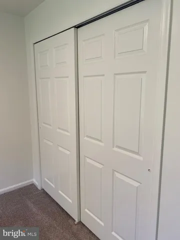 an empty room with closet area