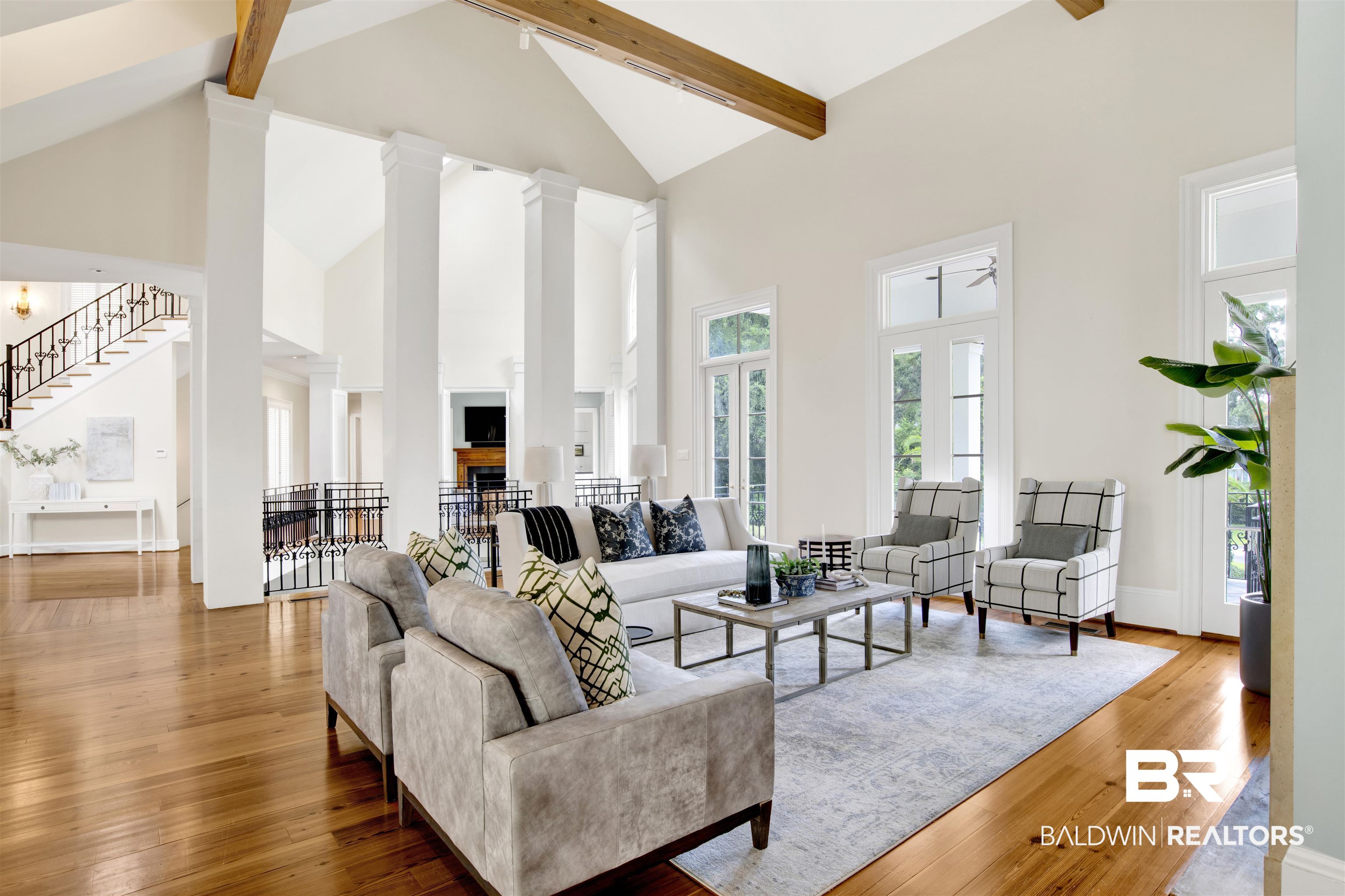 3816 Austill Lane Mobile, AL 36608 - Photo 13 of 80 Living room featuring high vaulted ceiling, beam ceiling, hardwood / wood-style floors, and stairway