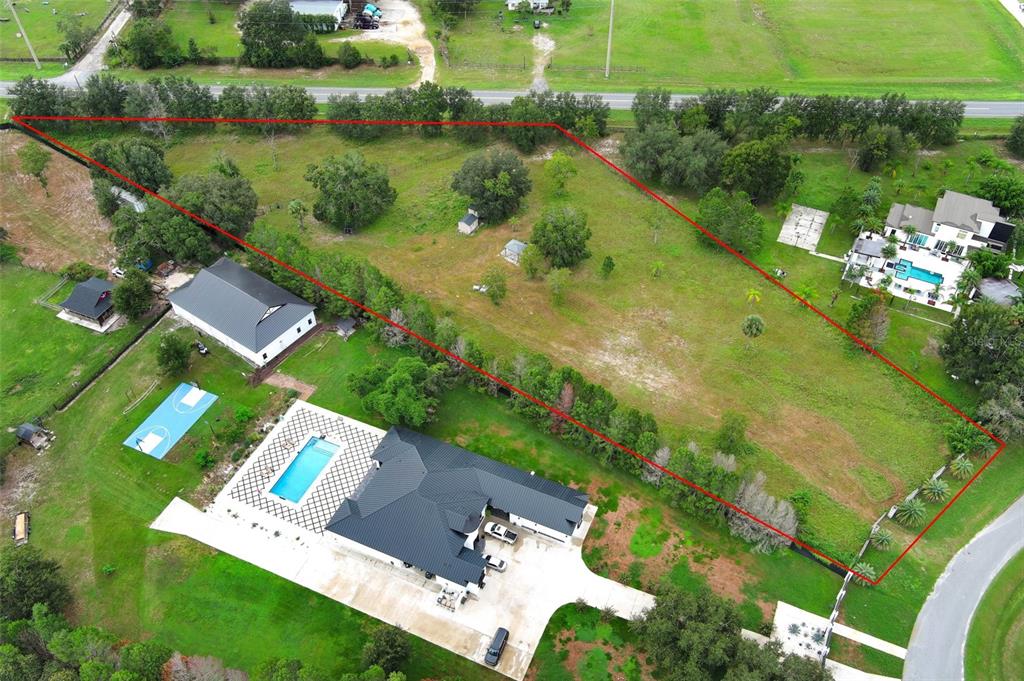 34534 Tree Frog Lane Eustis, FL 32736 - Photo 10 of 17 an aerial view of a house with a garden and lake view