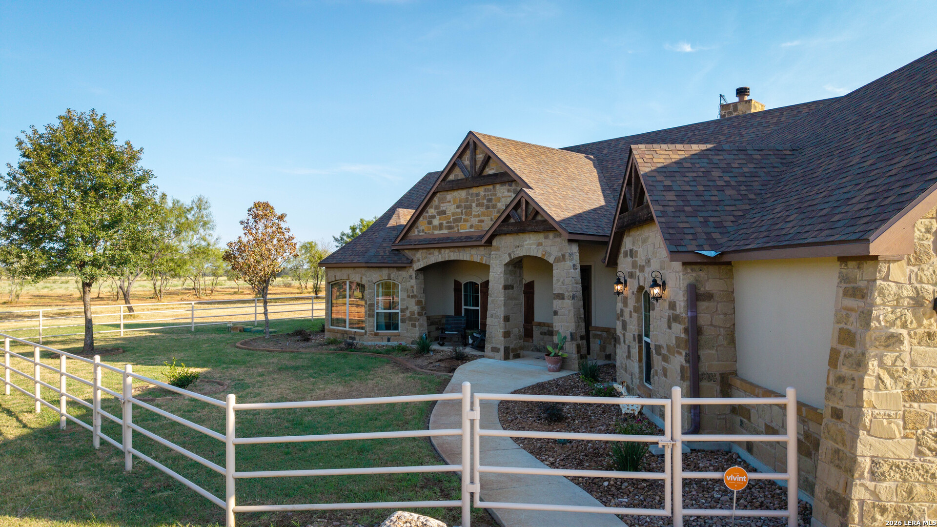 5002 Fm 476 Poteet, TX 78065 - Photo 21 of 50 a view of a house with a large window and a yard with plants