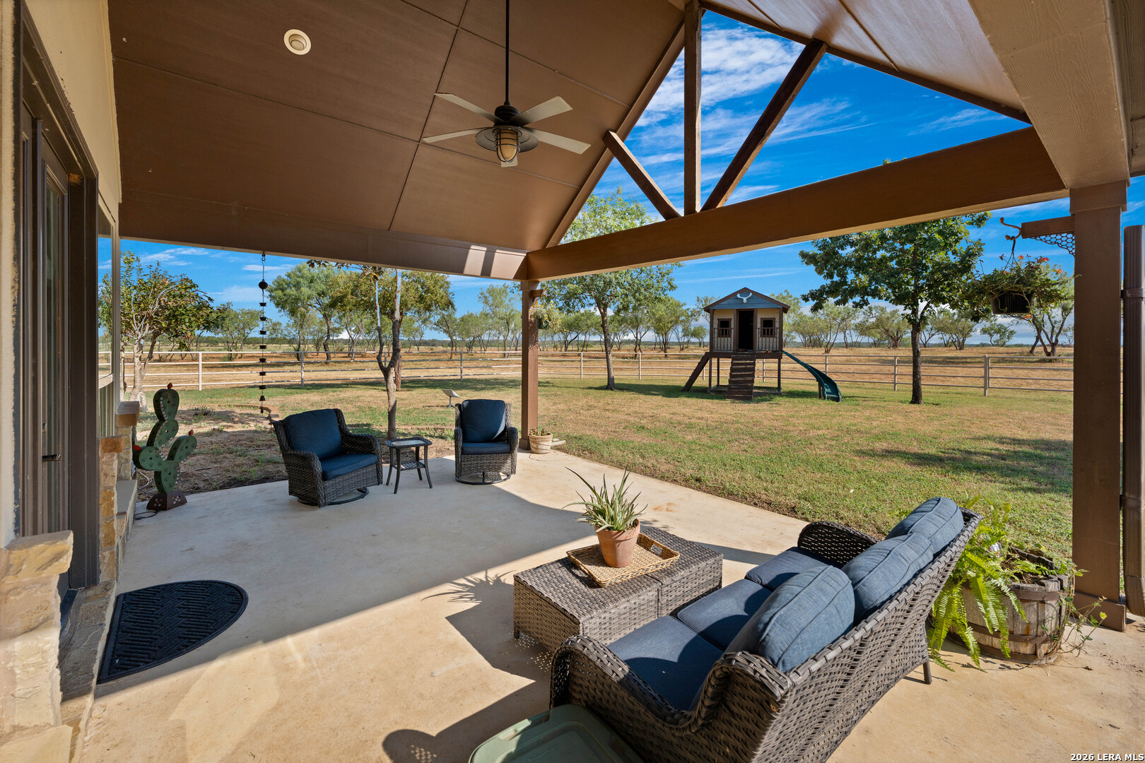 5002 Fm 476 Poteet, TX 78065 - Photo 48 of 50 a view of a patio with table and chairs under an umbrella