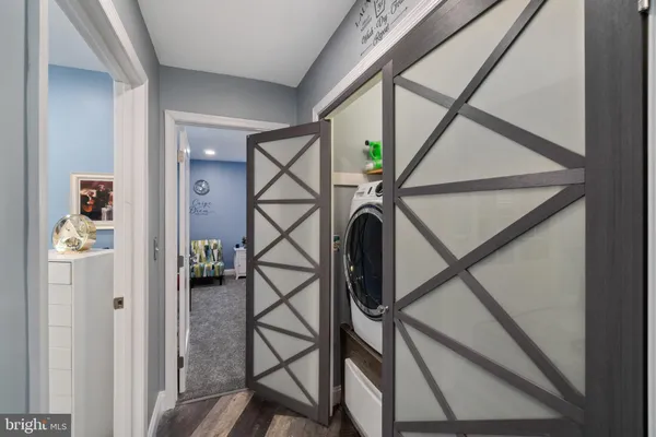 a kitchen with stainless steel appliances granite countertop a stove a sink dishwasher a dining table and chairs with wooden floor