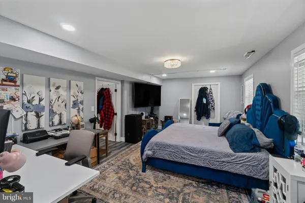 a bedroom with furniture and a flat screen tv