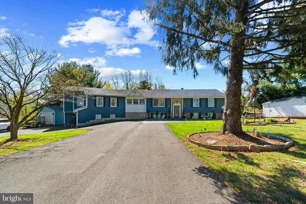 a front view of house with yard and green space