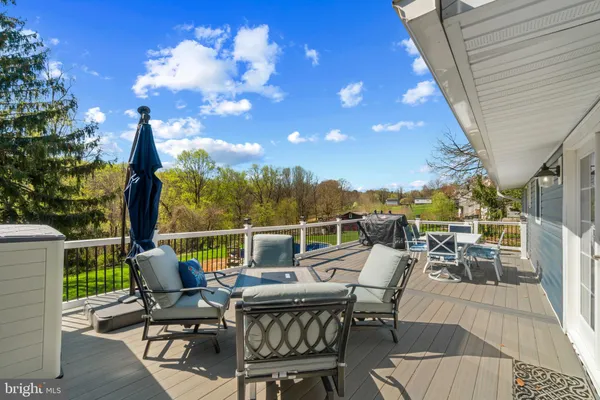 a view of a patio with table and chairs and potted plants