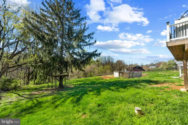 a front view of a house with a garden and deck