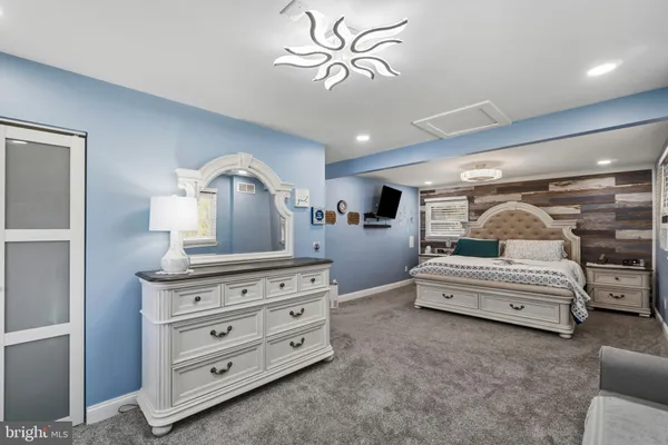 a bedroom with a bed and a dresser