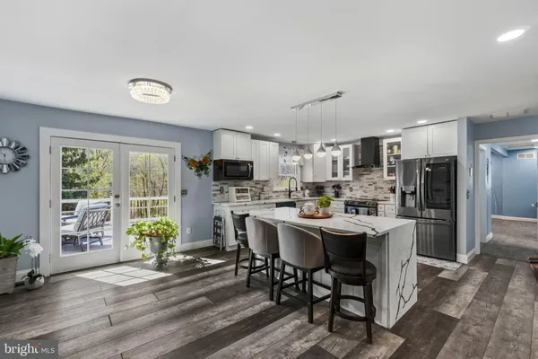 a kitchen with a table chairs refrigerator and microwave