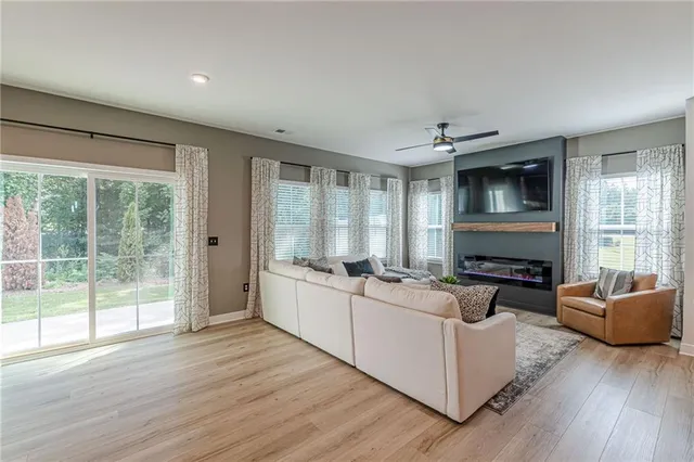 a living room with furniture fireplace and flat screen tv