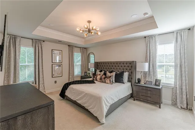 a spacious bedroom with a bed and dresser