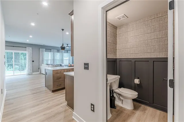 a bathroom with a toilet a sink and shower