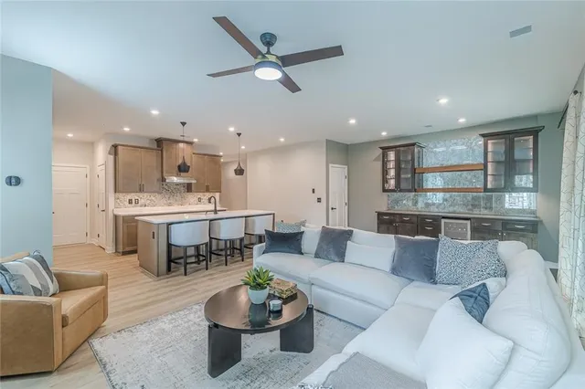 a living room with furniture kitchen and a table