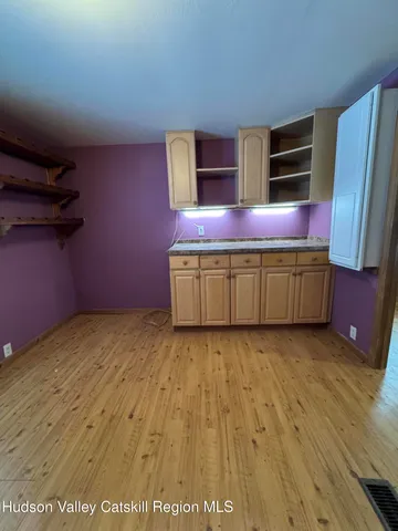 a room with wooden cabinets and stainless steel appliances