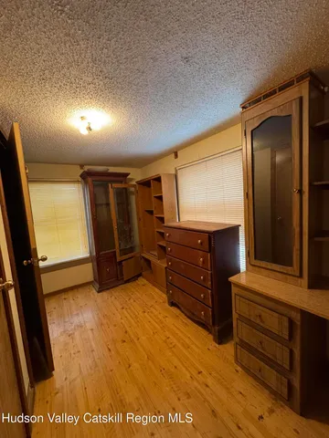 a view of room with wooden floor