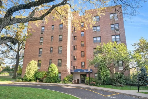 a view of a tall building next to a yard