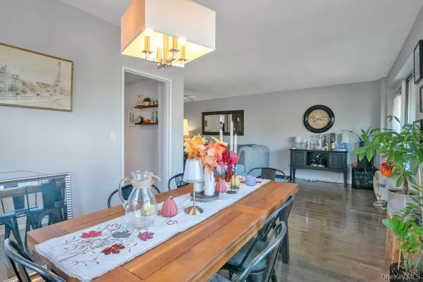 a view of a dining room with furniture and a chandelier