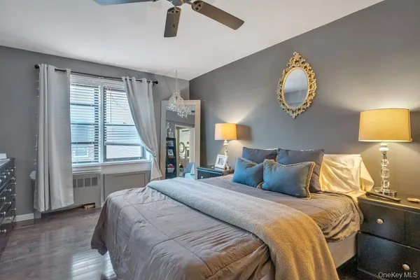 a bedroom with a large bed and a window