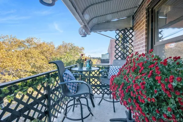 a view of a chairs and table in the balcony