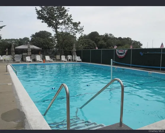 a view of a swimming pool with a back yard