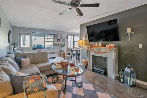 a living room with furniture a flat screen tv and a fireplace