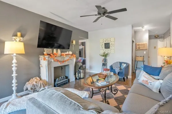 a living room with furniture a flat screen tv and a fireplace