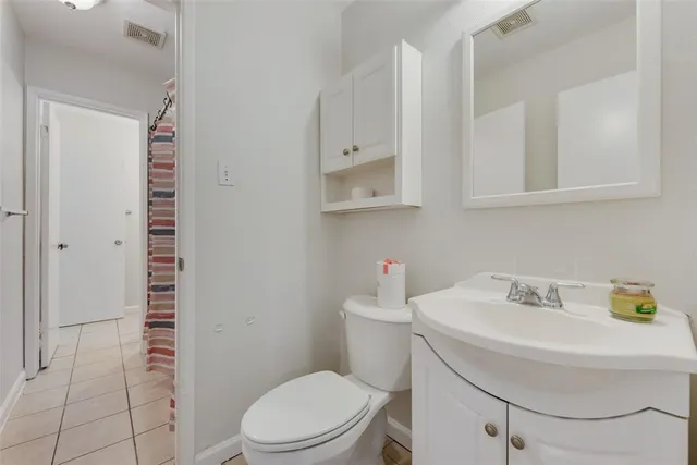 a bathroom with a sink toilet and mirror