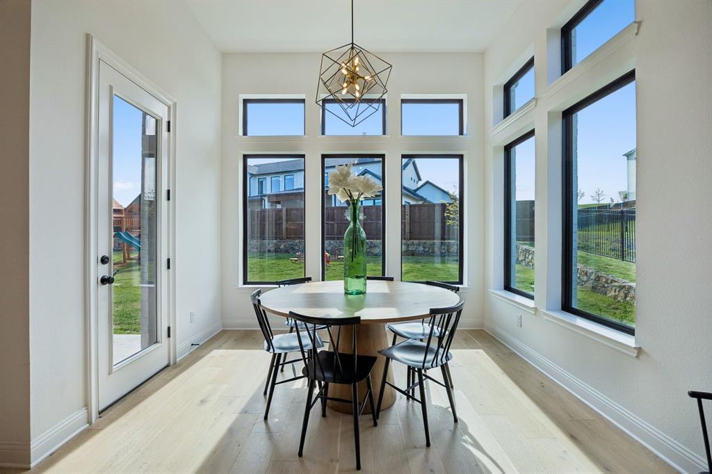1717 Tolleson Drive Fort Worth, TX 76008 - Photo 11 of 40 a dining room with furniture a chandelier and wooden floor