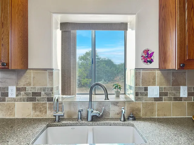 a kitchen with a sink and a large window
