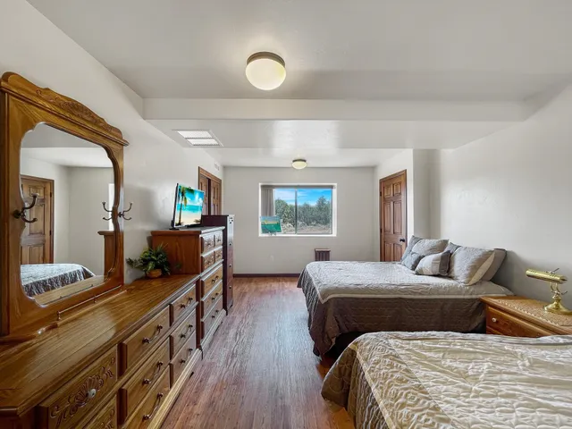 a bedroom with two beds and a large window