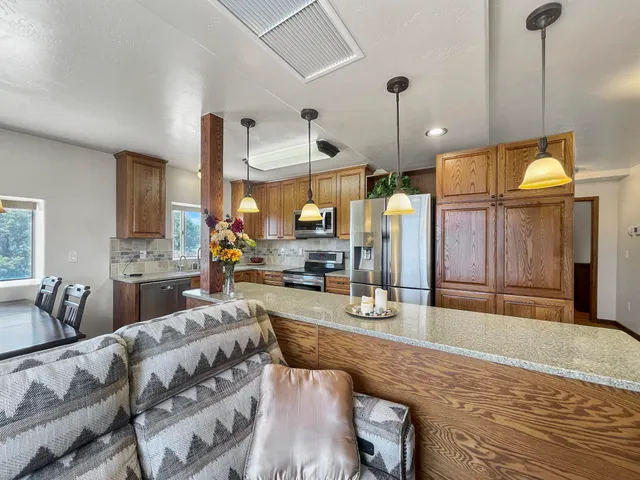 a living room with furniture and a chandelier