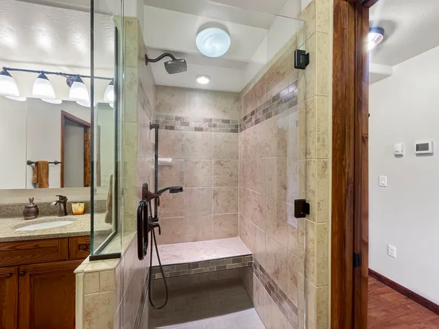 a bathroom with a shower and a sink