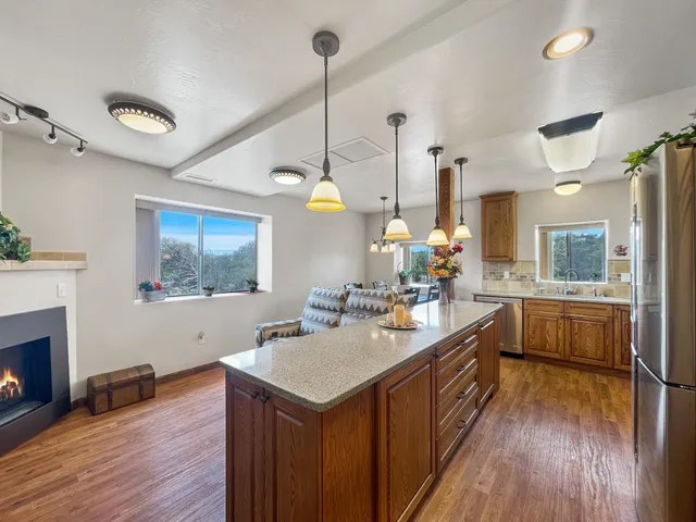 a kitchen with a sink stove and wooden floor