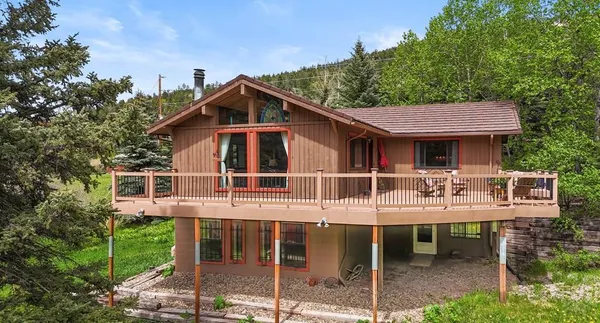 a view of a house with backyard porch and sitting area