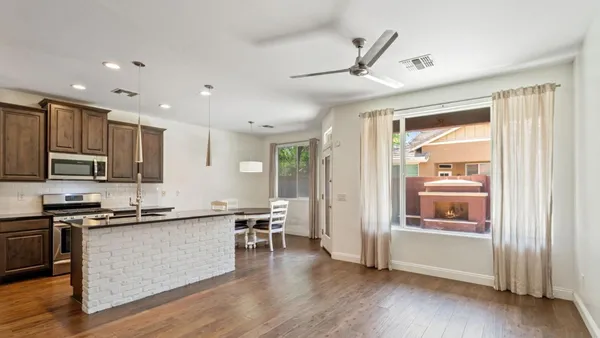 a kitchen with stainless steel appliances kitchen island granite countertop a stove and a refrigerator