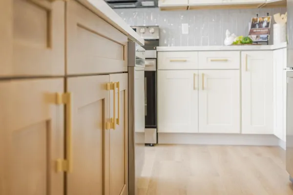 a kitchen with stainless steel appliances white cabinets and a stove top oven