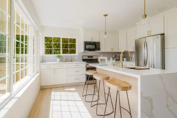 a kitchen with a refrigerator sink and stove