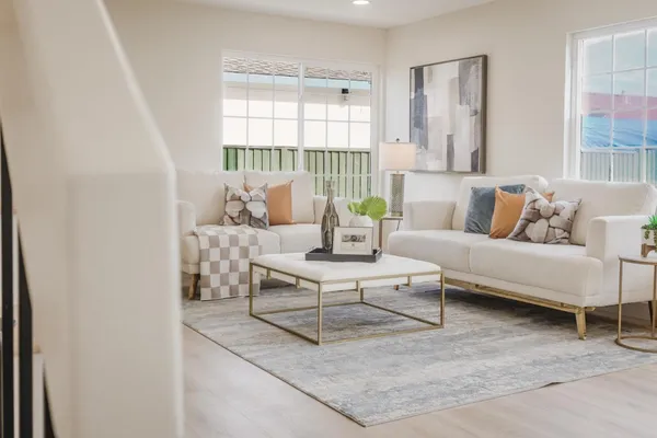 a living room with furniture and a potted plant