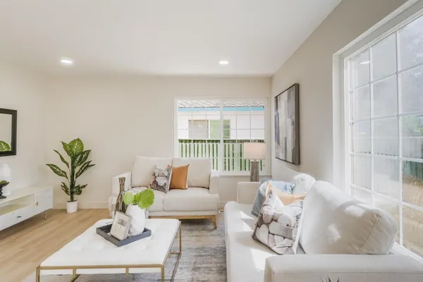 a living room with furniture and wooden floor